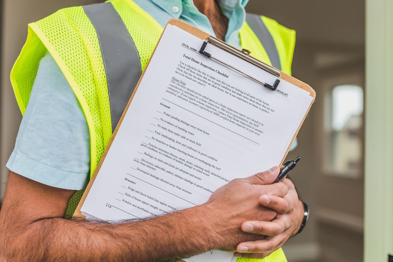 Inspector reviewing a home roof inspection checklist on a clipboard